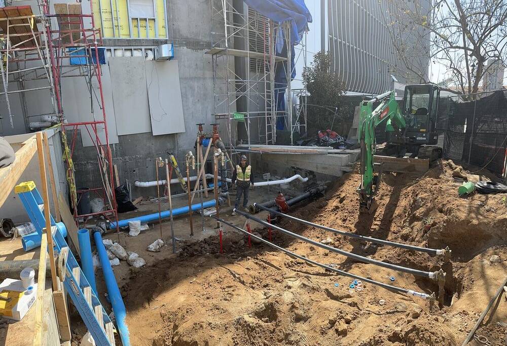 Underground water and fireline utility installation in a dense urban corridor